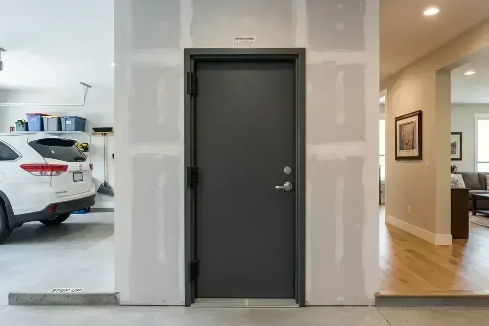 Gas-sealed garage demising wall and solid-core fire door